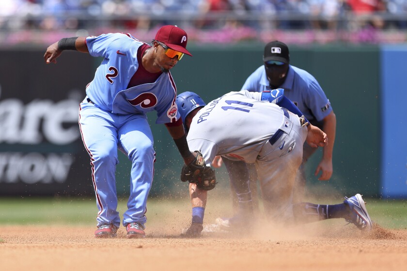 The Dodgers' AJ Pollock steals second base before the tag by Phillies second baseman Jean Segura.