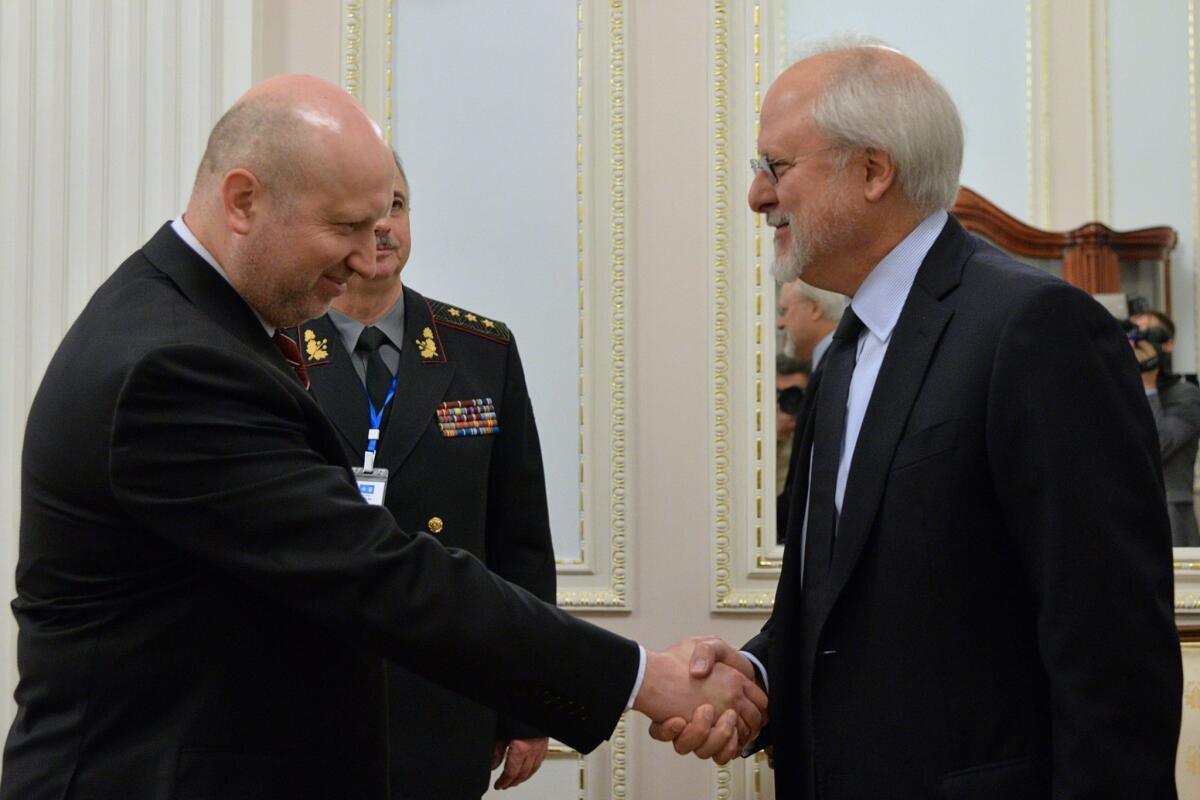 Ukrainian National Security and Defence Council chief Oleksandr Turchynov, left, greets NATO security chief Thrasyvoulos Terry Stamatopoulos in Kiev on May 27.