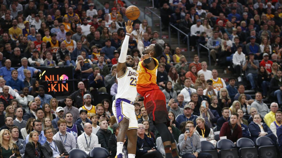 LeBron James puts up a shot over Jazz forward Jeff Green during a game Dec. 4.