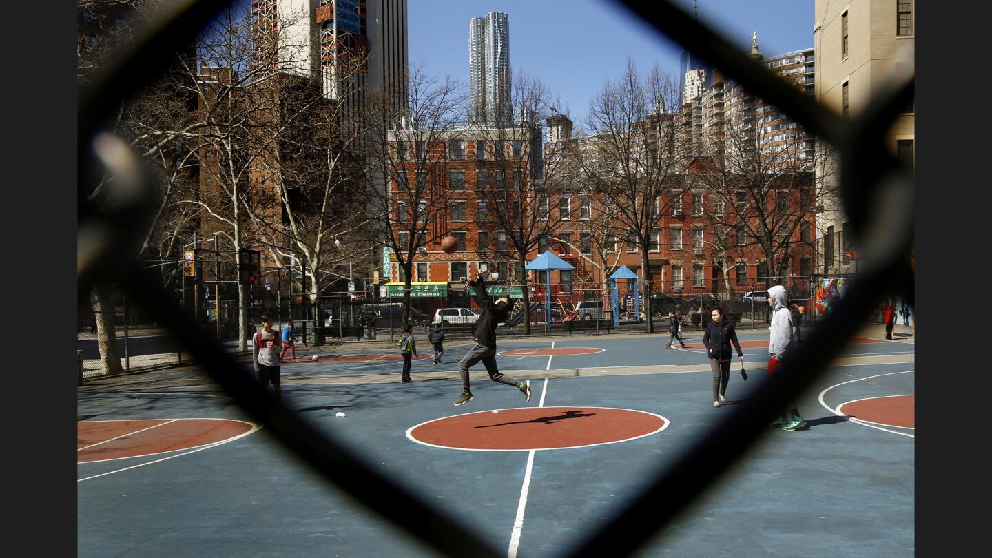 Children play basketball on the edge of New York's Chinatown, where there is a mix of cultures.
