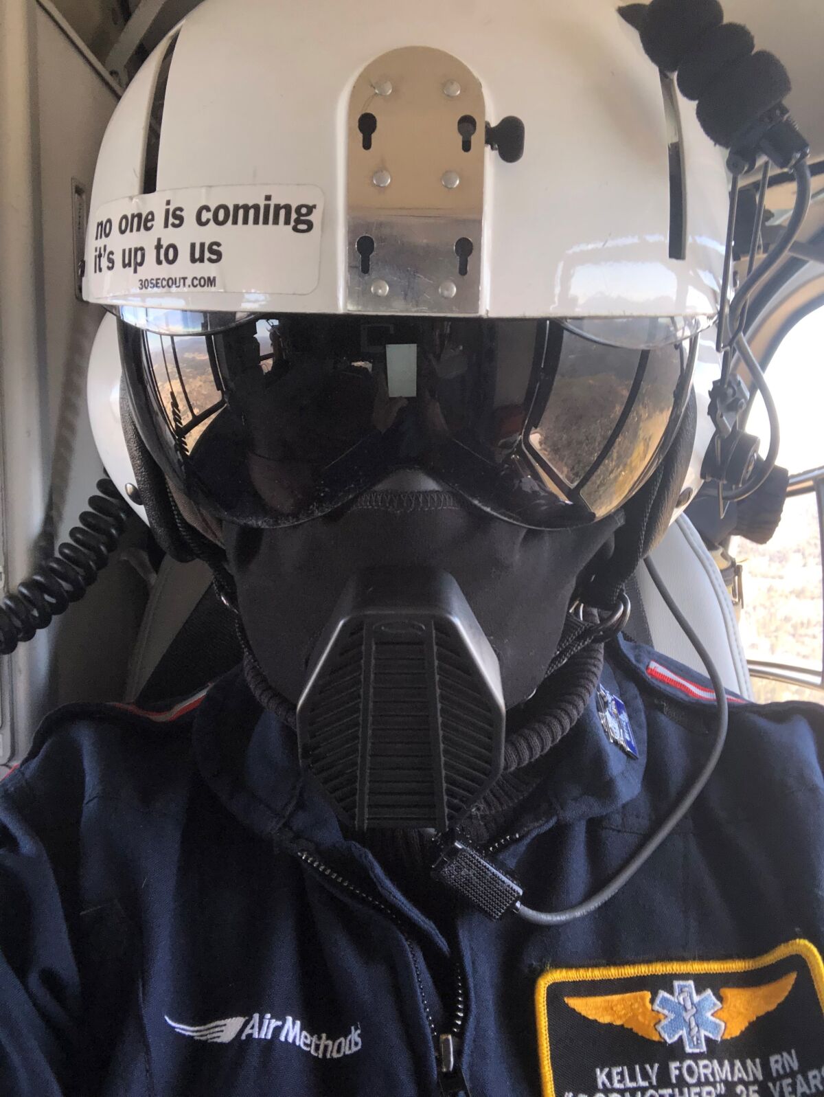 San Diego-based flight nurse Kelly Forman wearing her personal protective equipment onboard a Mercy Air helicopter