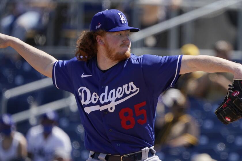 Los Angeles Dodgers' Dustin May pitches in the first inning of a spring training baseball game.
