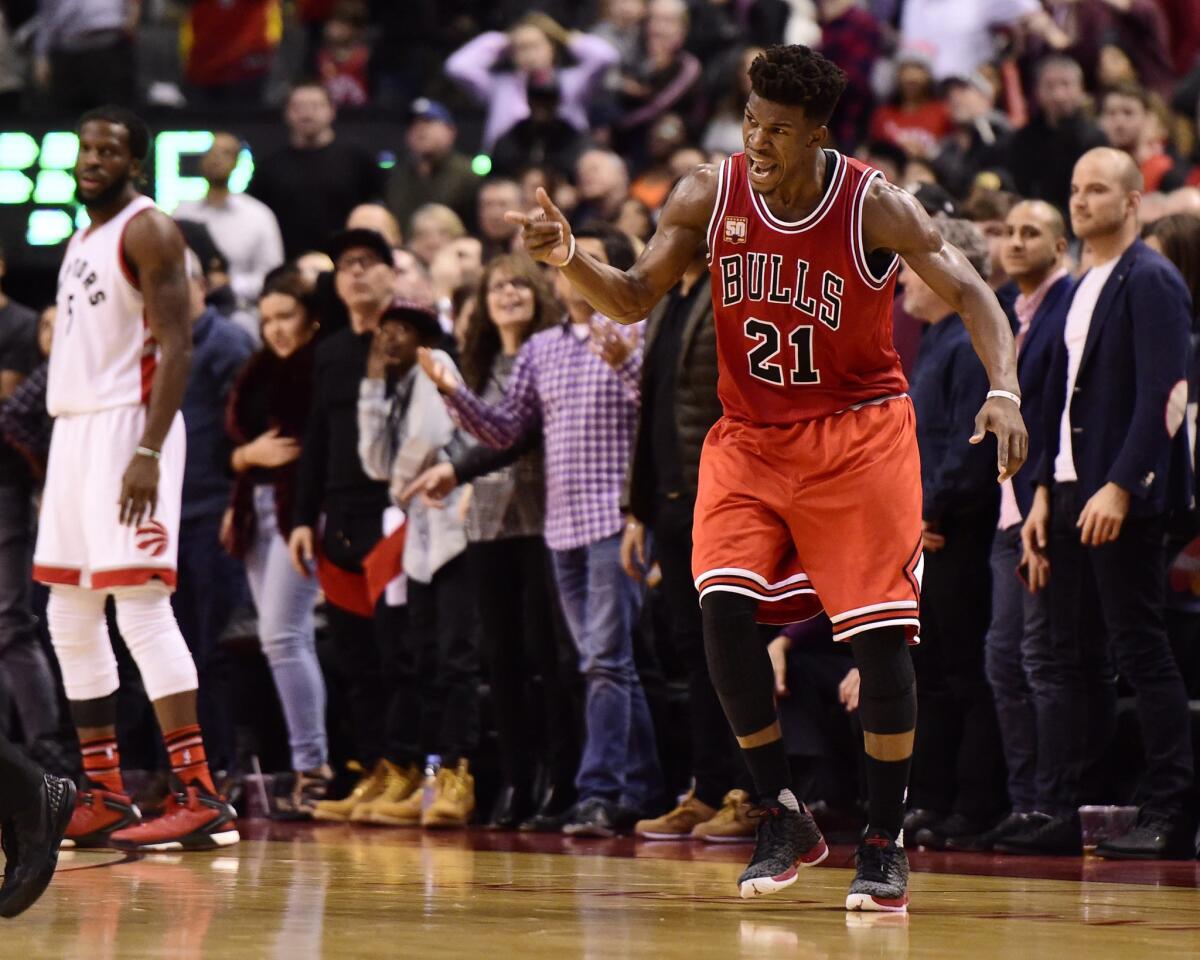 Bulls guard Jimmy Butler celebrates a three-point basket against the Toronto Raptors during his 40-point second half barrage.