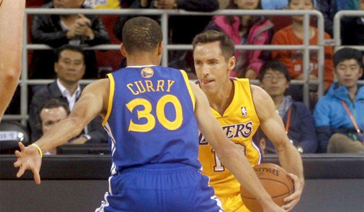 Steve Nash is defended by Golden State's Stephen Curry during an exhibition game in Beijing.
