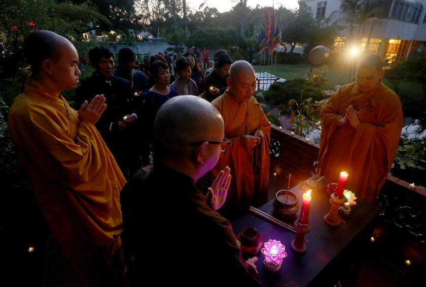  Buddhist monks lead prayers during a vigil for victims.