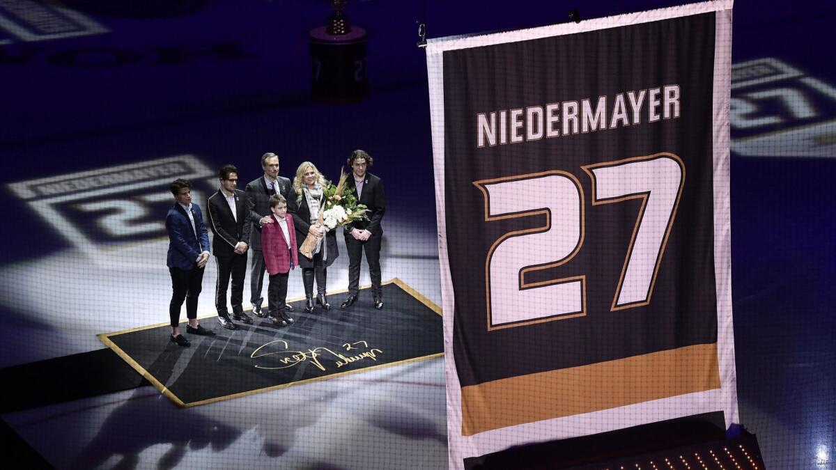 Former Ducks defenseman Scott Niedermayer watches along with his family as his jersey is retired prior to the game between the Ducks and the Washington Capitals.