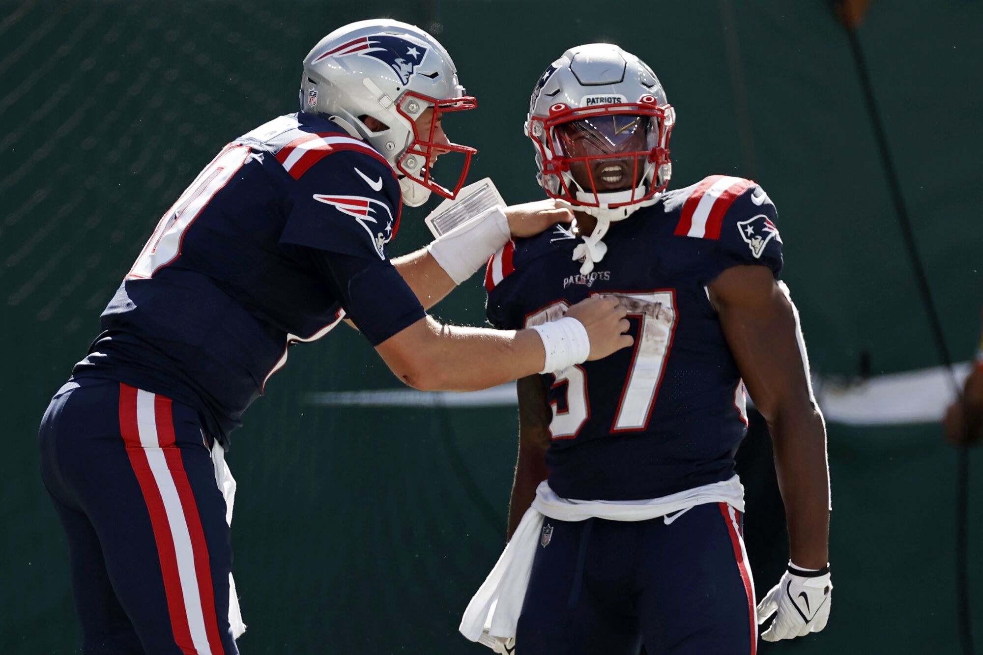 New England Patriots running back Damien Harris celebrates a touchdown with quarterback Mac Jones.