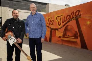 Tijuana, Baja California - April 24: Daniel Atkinson and Julian Plascencia founders/producers of the San Diegio Tijuana International Jazz Festival, which will debut on both sides of the border in October, including on outdoor stages on several blocks of Avenida Revolucion. Julian Plascencia and Daniel Atkinson pose for a photo near a mural in Downtown on Wednesday, April 24, 2024 in Tijuana, Baja California. (Alejandro Tamayo / The San Diego Union-Tribune)