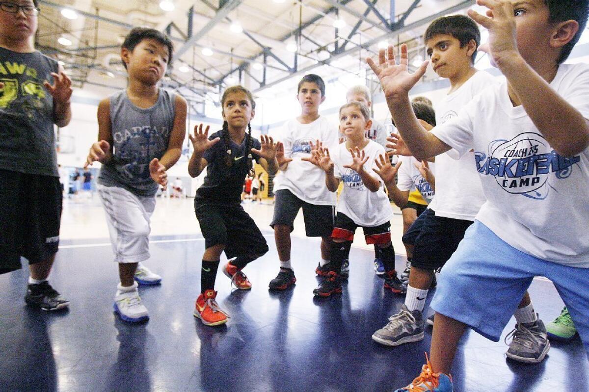 The youngest of the basketball campers learn the ready position to receive a pass as a shooter at Coach Z's Basketball Camp at Crescenta Valley High.