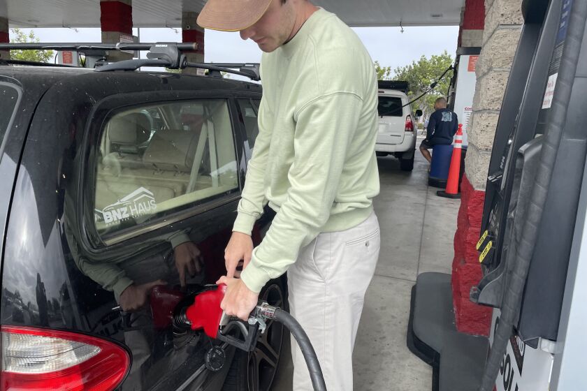 Ryan Krug fills up his tank at the Costco gas station in Carlsbad.