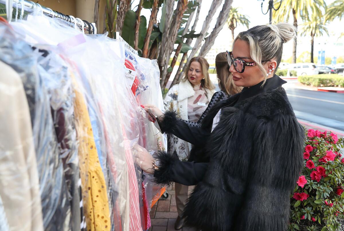 Sarah Hajali , right, who donated several coats, looks over the other donations.