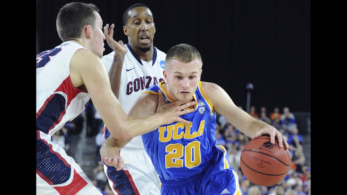 UCLA guard Bryce Alford gets a hand to the chest from Gonzaga forward Kely Wiltjer as he drives past guard Byron Wesley in the second half.