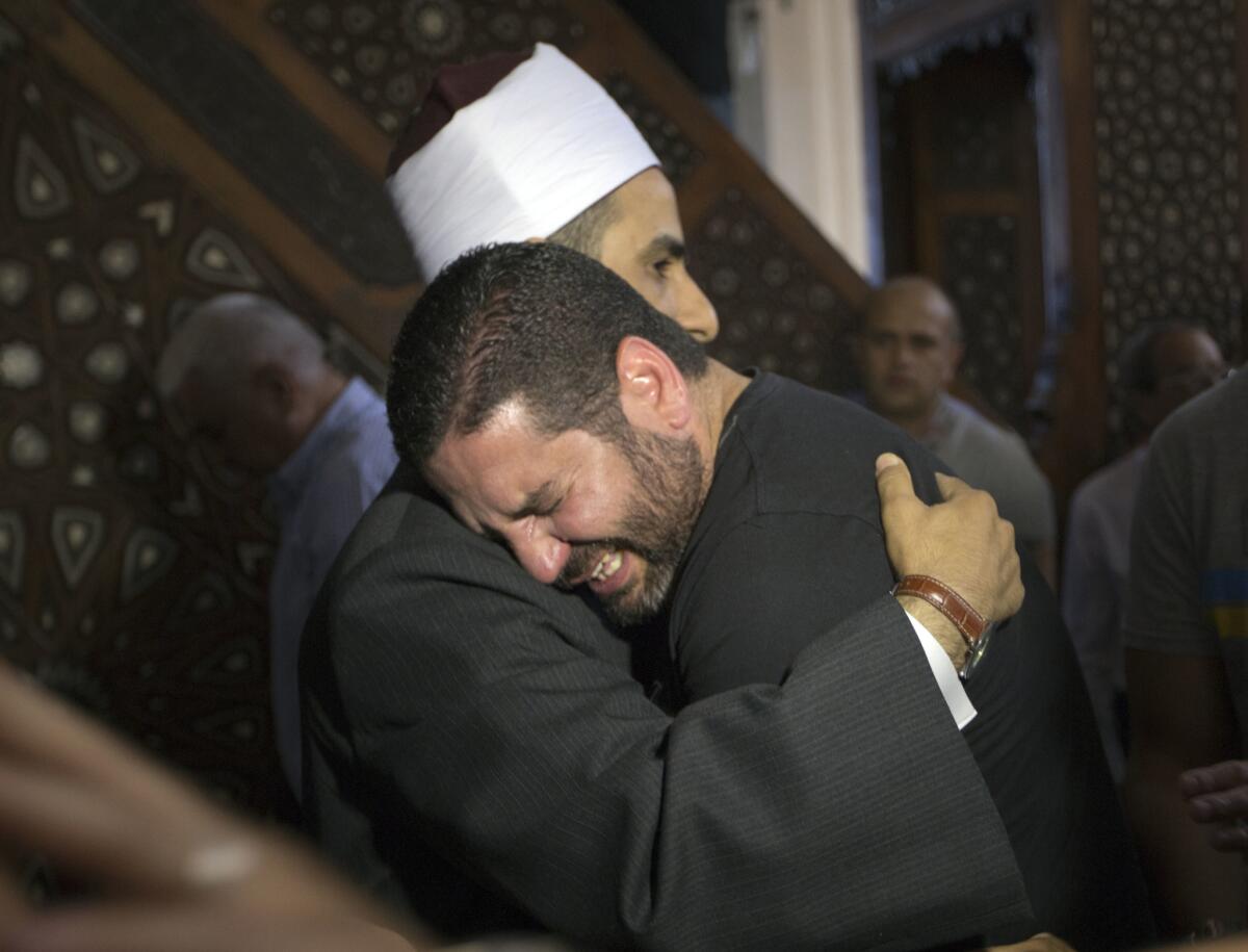 The imam of Cairo's Al Thawrah Mosque, Samir Abdel Bary, comforts Osman Abu Laban, who lost four relatives in the EgyptAir crash.