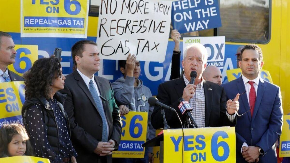Republican gubernatorial candidate John Cox addresses a Yes on Proposition 6 rally on Oct. 18 in Burbank. At left are Assembly candidate Roxanne Hoge and Carl DeMaio, chairman of the Yes on 6 campaign, and Republican candidate for controller Konstantinos Roditis at right.