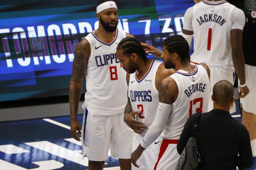 Los Angeles Clippers forward Marcus Morris Sr. (8) and guard Paul George (13), right, congratulate forward Kawhi Leonard (2) after they defeated the Dallas Mavericks in Game 6 of an NBA basketball first-round playoff series in Dallas, Friday, June 4, 2021. (AP Photo/Michael Ainsworth)