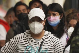 People wait outside a pharmacy to get tested for COVID-19, in Mexico City, Monday, Jan. 10, 2022. (AP Photo/Marco Ugarte)