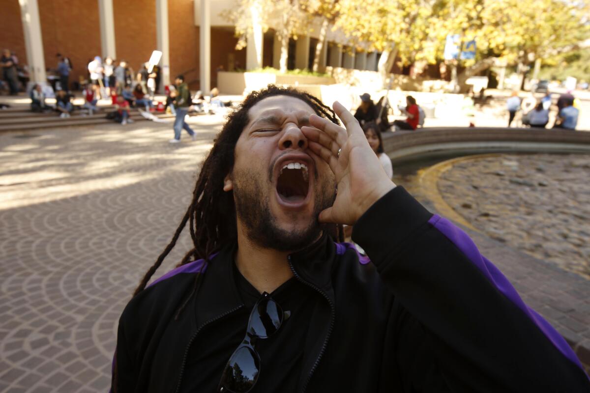 A man cups his hand around his mouth and yells