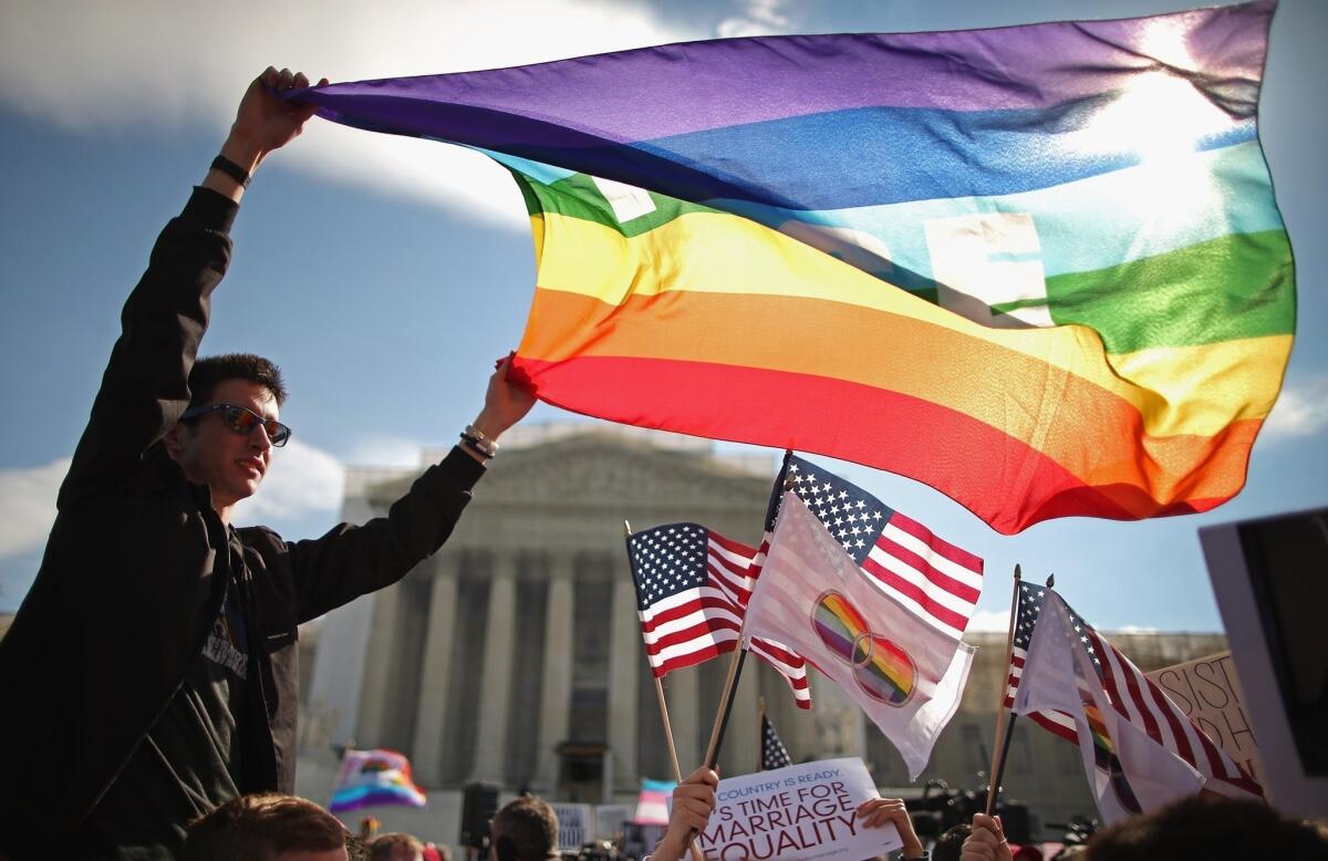 Hundreds rally outside the Supreme Court building in Washington, D.C., during oral arguments in a case challenging the Defense of Marriage Act last March.
