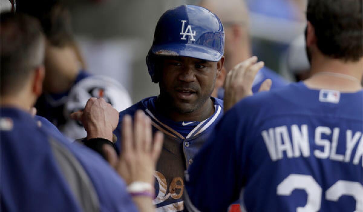 Carl Crawford is congratulated in the dugout after scoring the Dodgers' only run in a 4-1 loss to the Arizona Diamondbacks on Wednesday in Scottsdale, Ariz. Crawford said he felt tightness in his leg after scoring from first base on Yasiel Puig's double and was not in the lineup on Thursday.