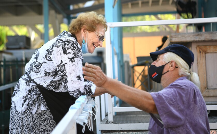 Gloria Suess talks to a friend at Mary's Kitchen in Orange.