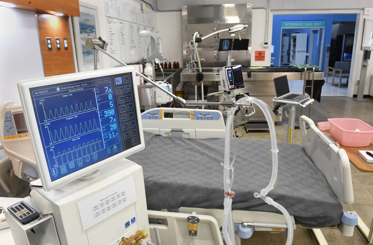 A hospital room full of monitors and other healthcare equipment.