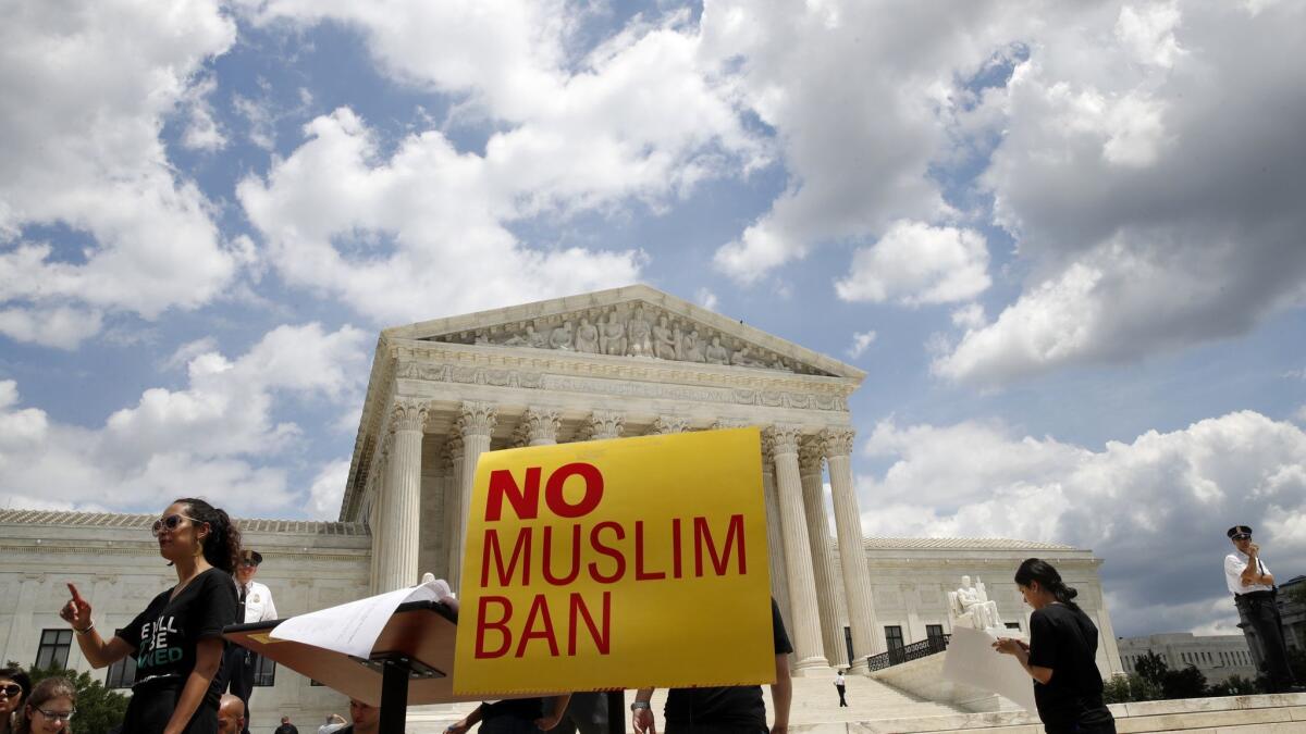 People protest against the Supreme Court ruling upholding President Trump's travel ban on June 26.