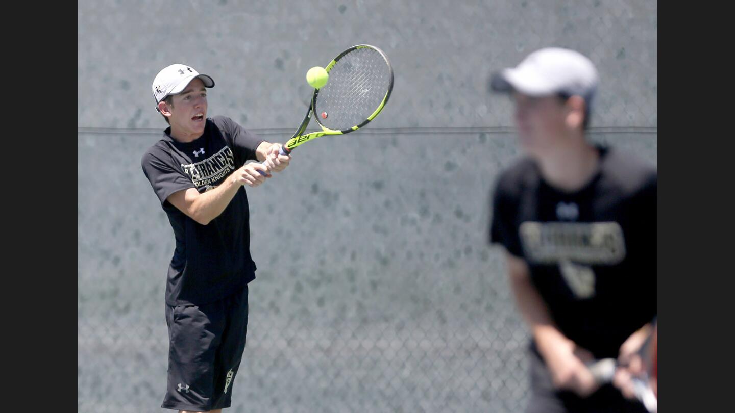St. Francis High School doubles tennis player Ian Freer, left, returns the ball as partner Jack Freer looks on at right, in the 2017 Mission League Individual Tournament semifinal match at L.A. Valley College in Los Angeles on Thursday, May 4, 2017.