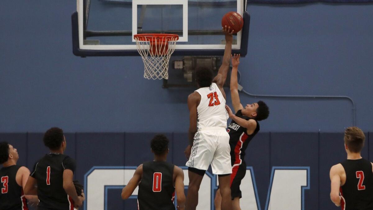 Pacifica Christian Orange County High's Judah Brown (23) blocks Eaglecrest's Zion Ruckard during the first half at the Corona del Mar Beach Bash on Tuesday.