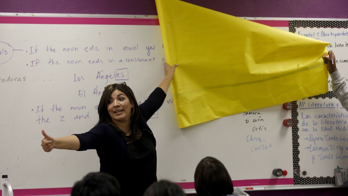 Teacher Viviane Barrios instructs her class at Downtown Magnets High School in 2016. Schools and school districts are struggling to elevate scores on state tests.