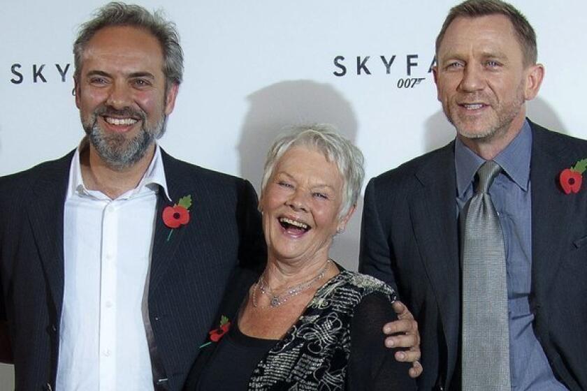 Director Sam Mendes, left, and actors Dame Judi Dench and Daniel Craig at a press event for "Skyfall" in 2011. Mendes says he won't direct the next James Bond film.