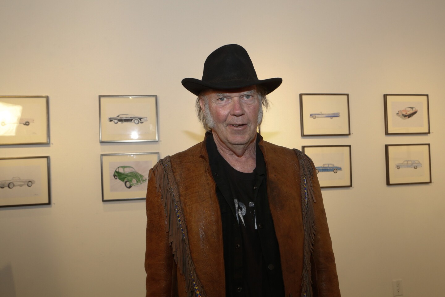 Neil Young with his watercolors and prints of iconic automobiles that he grew up with. His show is at the Robert Berman Gallery, Bergamont Station Arts Center in Santa Monica.