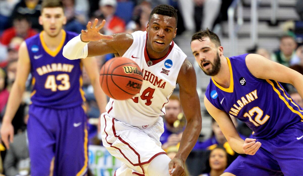 Oklahoma guard Buddy Hield steals the ball in front of Albany guard Peter Hooley during the Sooners' 69-69 victory over the Great Danes on Friday. at Nationwide Arena in Columbus, Ohio.