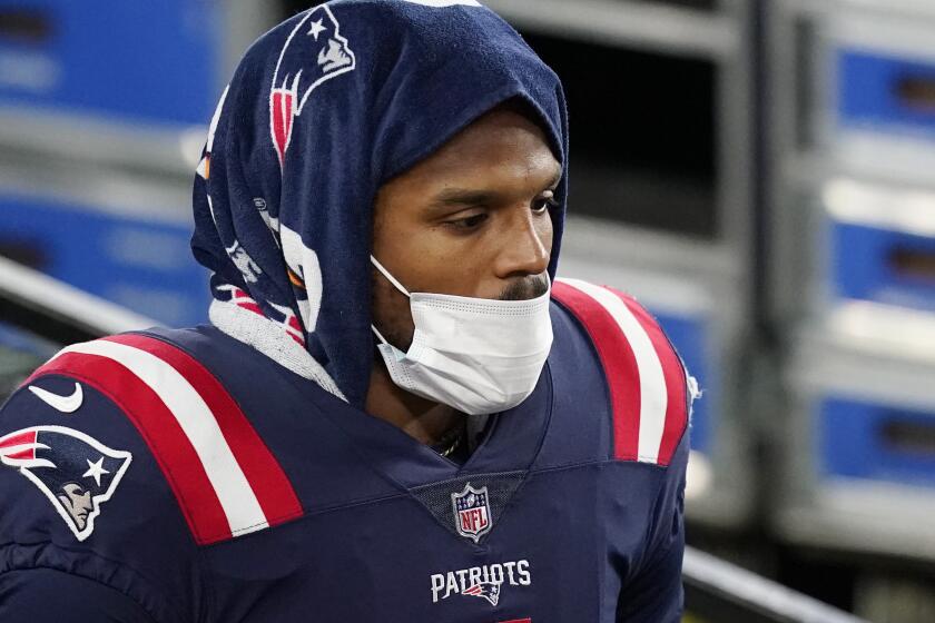 New England Patriots quarterback Cam Newton walks along the sideline in the first half of an NFL football game against the Buffalo Bills, Monday, Dec. 28, 2020, in Foxborough, Mass. (AP Photo/Elise Amendola)