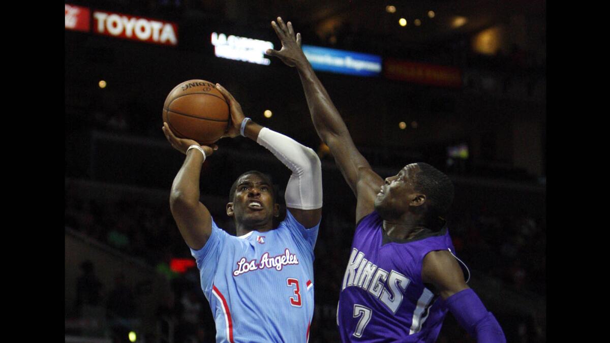 Clippers point guard Chris Paul (3) goes to the basket against Sacramento Kings point guard Darren Collison at Staples Center on Nov. 2.