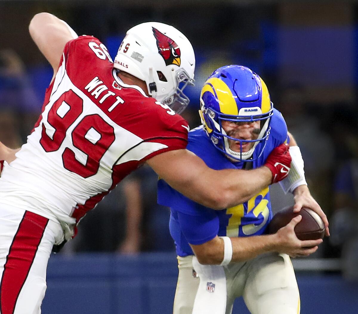 Cardinals defensive end J.J. Watt sacks Rams quarterback John Wolford in the first half Sunday.