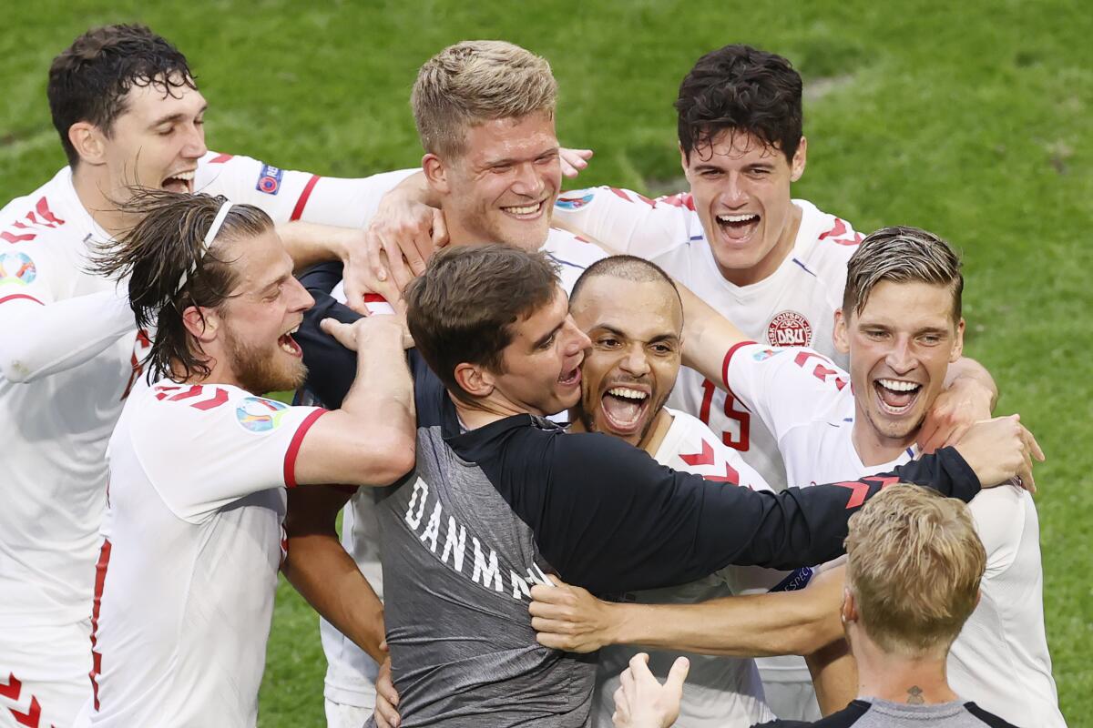 Denmark's Martin Braithwaite, center, celebrates with his teammate after scoring