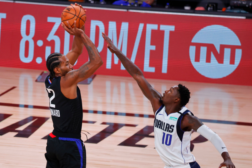 LAKE BUENA VISTA, FLORIDA - AUGUST 30: Kawhi Leonard #2 of the LA Clippers shoots against Dorian Finney-Smith.