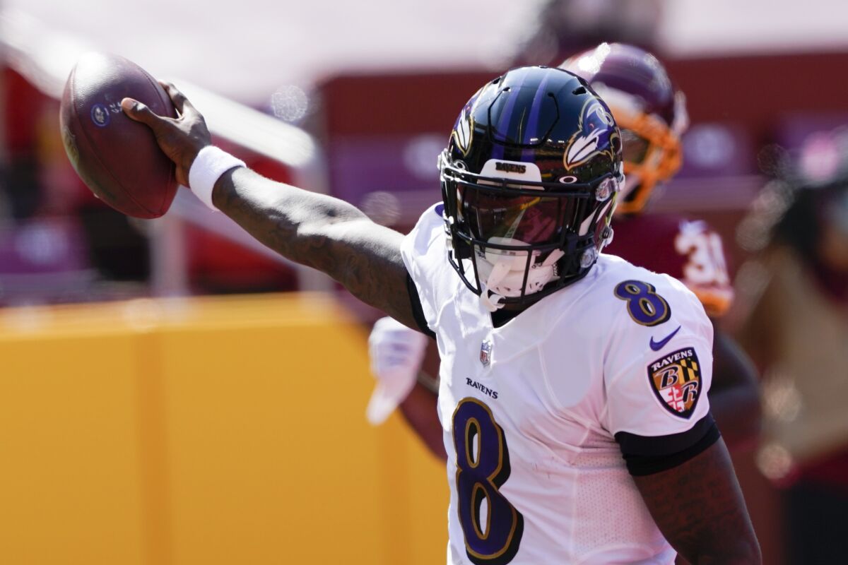 Baltimore Ravens quarterback Lamar Jackson (8) runs into the end zone for a touchdown against the Washington Football Team during the first half of an NFL football game, Sunday, Oct. 4, 2020, in Landover, Md. (AP Photo/Susan Walsh)