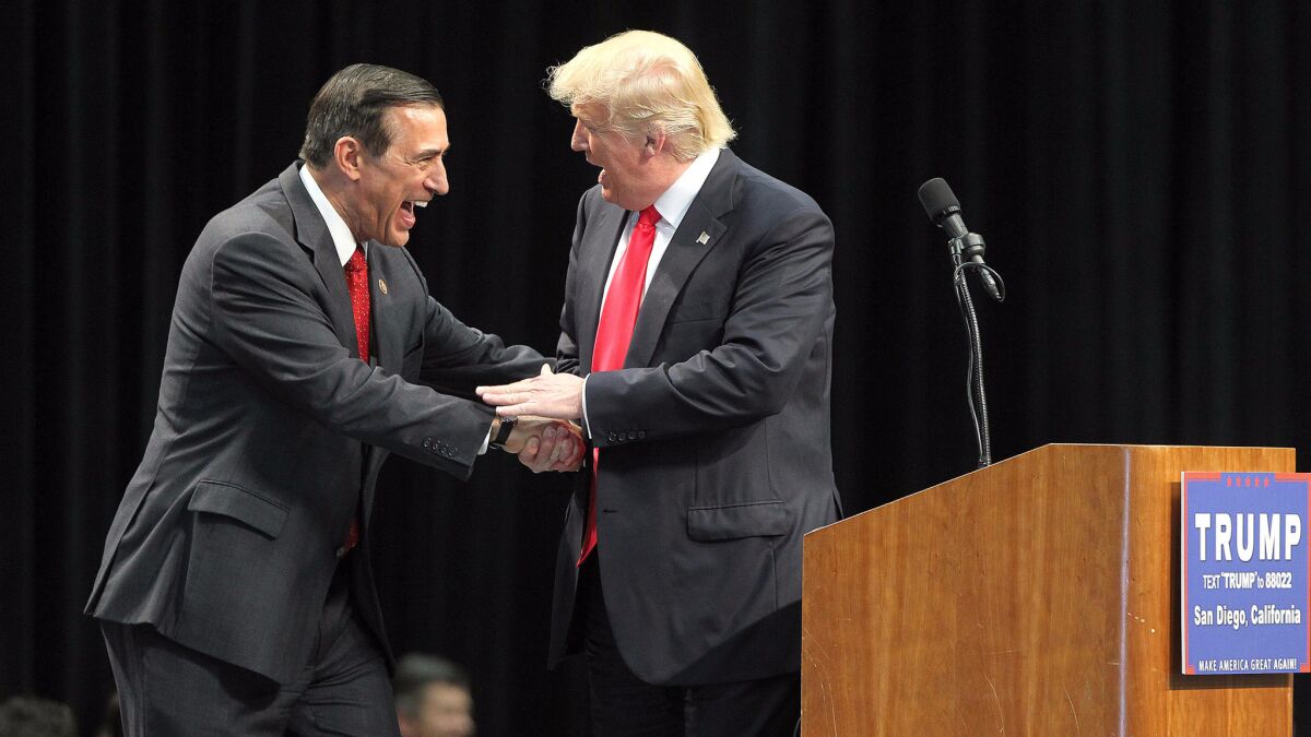 Rep. Darrell Issa (R-Vista), left, greets then-Republican presidential candidate Donald Trump during a campaign rally at the San Diego Convention Center on May 27.