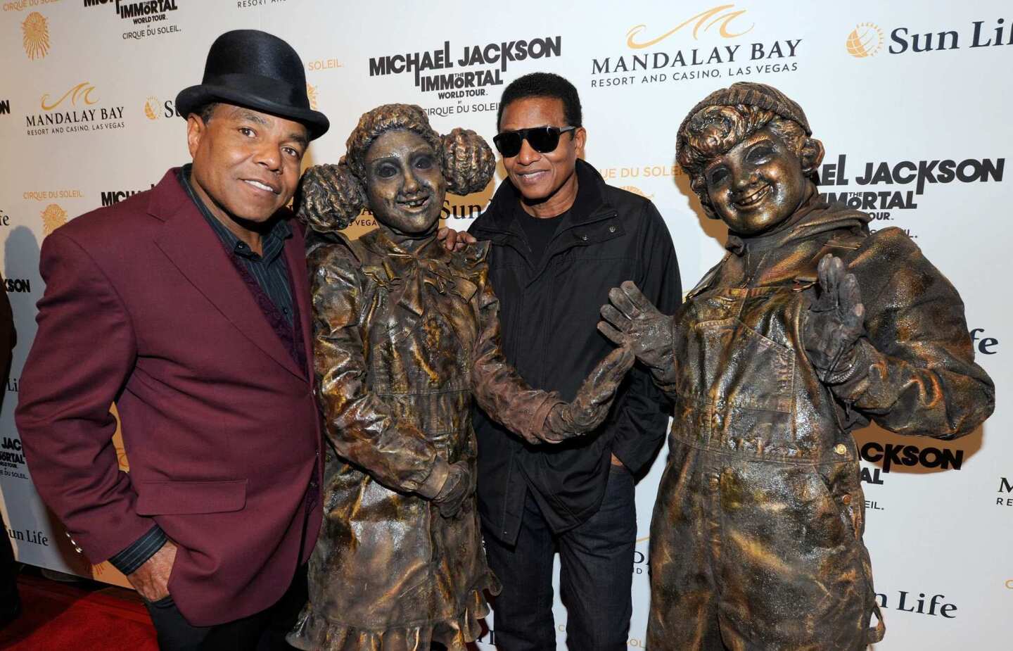 Tito Jackson and Jackie Jackson pose with Cirque du Soleil performers as they arrive at the Las Vegas premiere of "Immortal," Cirque du Soleil's tribute to Michael Jackson at the Mandalay Bay Resort and Casino. The show featuring the collected work of Michael Jackson will be performed through Dec. 27. After a world tour, it will set up a permanent home in Vegas in 2013.