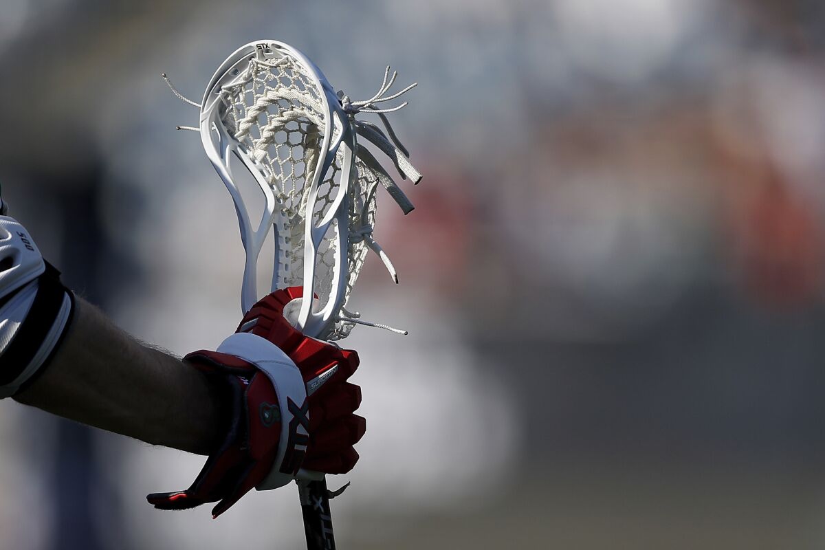 A closeup, detail view of a lacrosse stick.