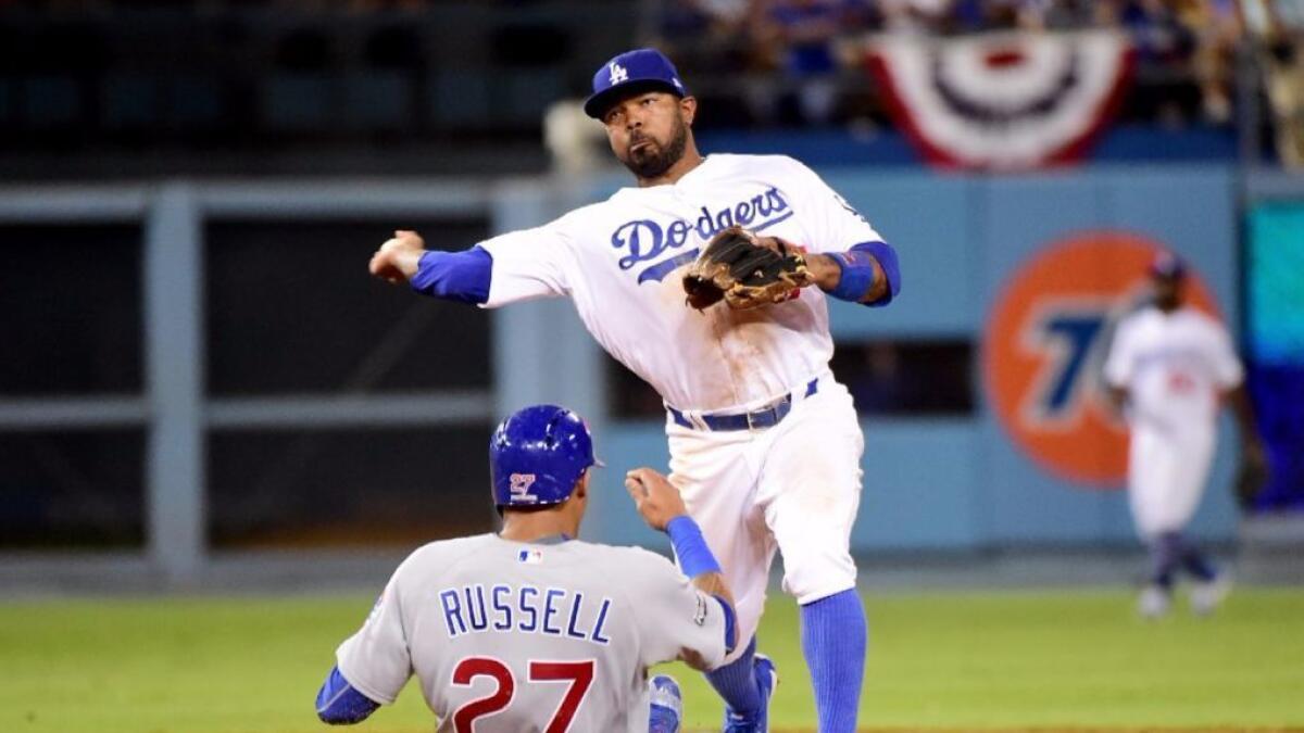 Howie Kendrick turns a double play from second base during Game 5 of the National League Championship Series against the Cubs on Oct. 20.