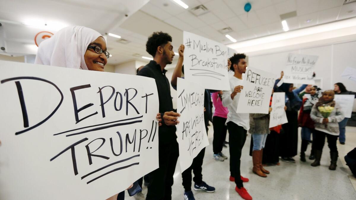 Protestors demonstrate against President Trump at the Dallas Forth Worth Airport on Jan. 28 in Dallas.