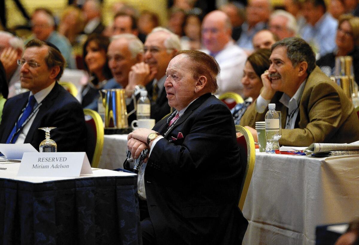 Republican donor Sheldon Adelson listens to New Jersey Gov. Chris Christie speak during the Republican Jewish Coalition conference in Las Vegas.