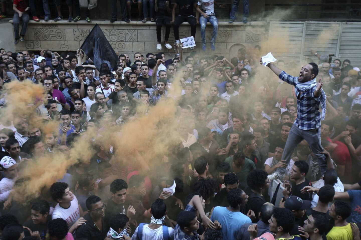 Protesters chant slogans as smoke rises outside the U.S. Embassy in Cairo. Demonstrators said Egyptian Coptic immigrants in the United States had made a video, posted on YouTube, that was anti-Muslim.