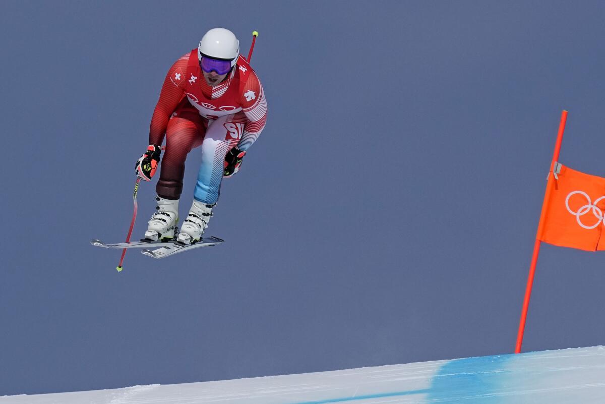 Beat Feuz of Switzerland soars over a crest on his way to winning gold in the men's downhill Monday.
