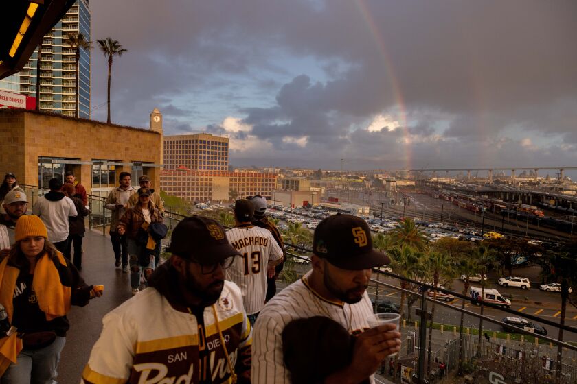 San Diego, CA - March 30: San Diego Padres fans walk past a rainbow that appeared while grounds crew tended to a wet field on Opening Day at Petco Park on Thursday, March 30, 2023 in San Diego, CA. (Sam Hodgson / The San Diego Union-Tribune)