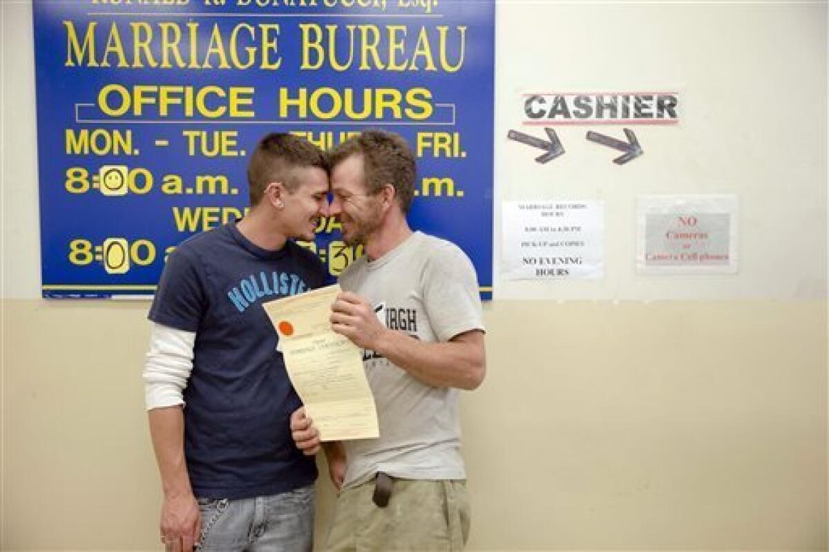 William Roletter, left, and Paul Rowe, with their newly acquired marriage certificate at Philadelphia City Hall on Wednesday.
