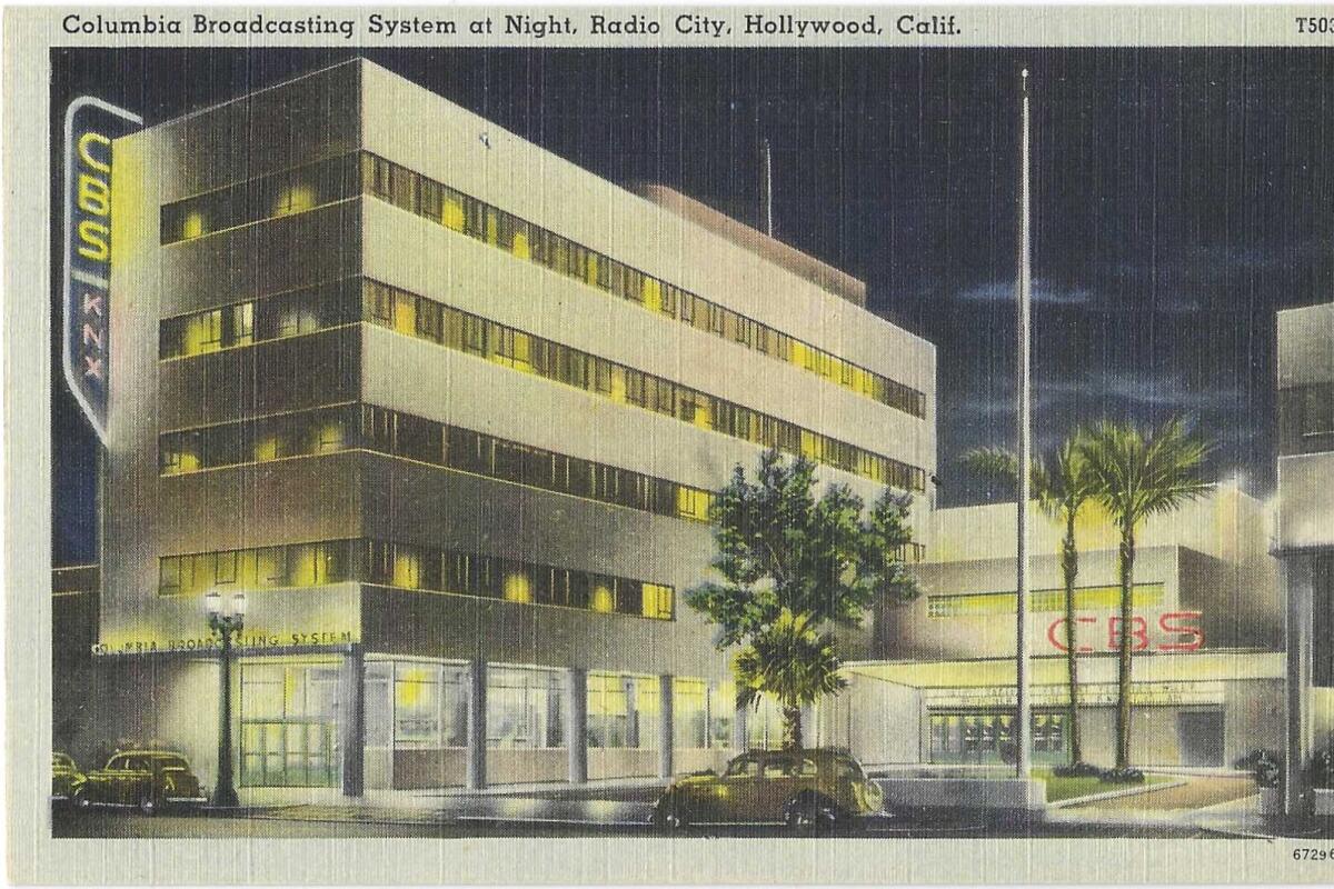 The sign for CBS and KNX is lighted on the side of the building on a vintage postcard.