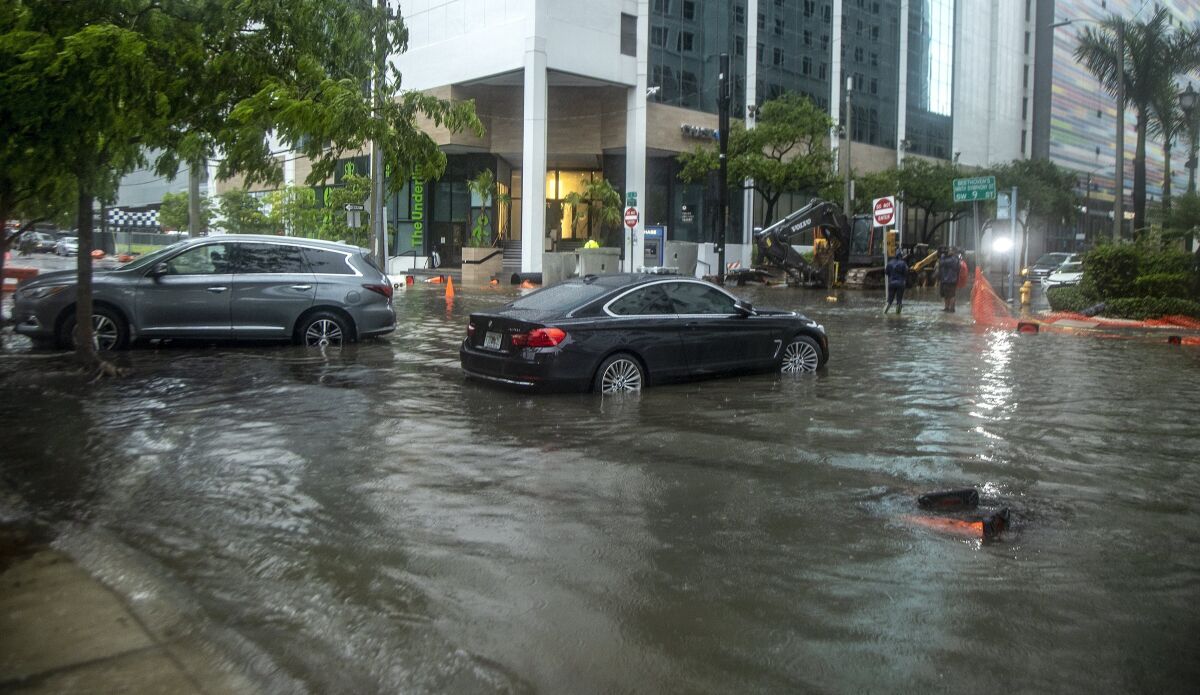 Cars on a flooded street.